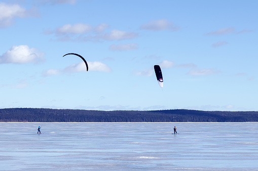 Snowkiting on a board on the Big Lake Onega in Karelia on a snow and ice surface, the city of Petrozavodsk.