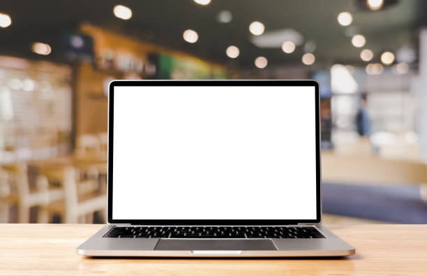 istock Laptop blank screen on wood table with coffee cafe background, mockup, template for your text, Clipping paths included for background and device screen 1478920632