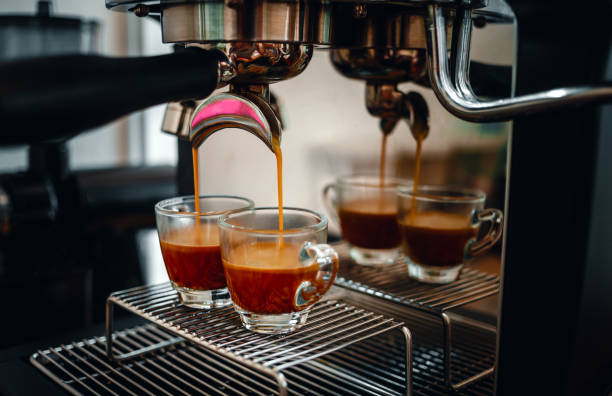 istock Professional espresso machine while preparing two espressos shot in a coffee shop. Close-up of espresso pouring from the coffee machine 1478923566