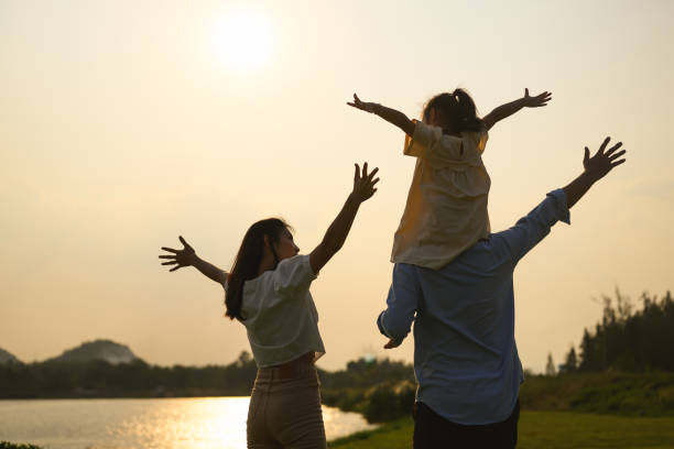 Family enjoying with outdoor activities travel trip on vacation Family enjoying with outdoor activities travel trip on vacation, Happy family father mother and children enjoying picnic at park, Family with happy lifestyle life insurance stock pictures, royalty-free photos & images