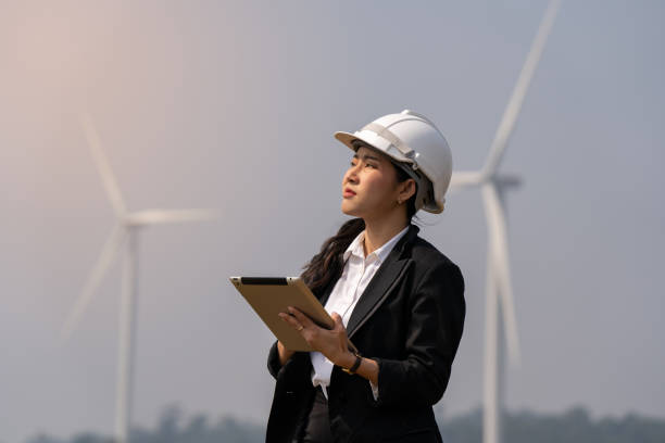 istock Female engineer planning on wind turbine maintenance work, nature renewable energy concept, wind power 1478934523