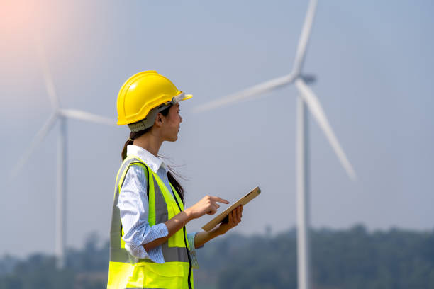 istock Female engineer planning on wind turbine maintenance work, nature renewable energy concept, wind power 1478934525