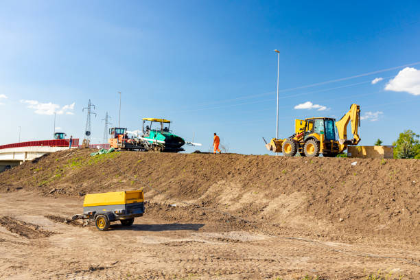 istock Heavy mechanization on construction site. Tarmac road laying machine, air compressor and excavator parked at building site zone. 1478935296