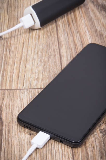 istock External powerbank using to charge empty battery of black smartphone 1478937233