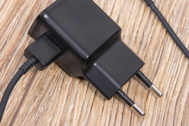 istock Charger using to charge empty battery of smartphone. Various devices charging concept 1478937249