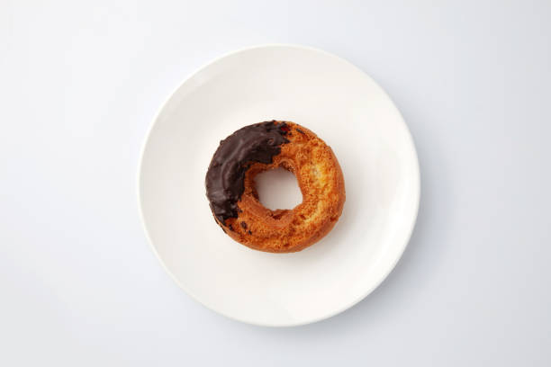 istock old fashioned doughnut chocolate on plate isolated on white background 1478940655
