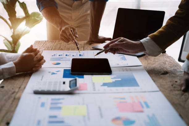 istock Teamwork process, Business team using a calculator to calculate the numbers of statistic business profits growth rate on documents graph data, papers having discussion in office. 1478942981
