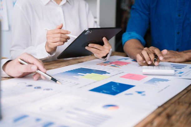 istock Teamwork process, Business team using a calculator to calculate the numbers of statistic business profits growth rate on documents graph data, desk in the office. 1478943490