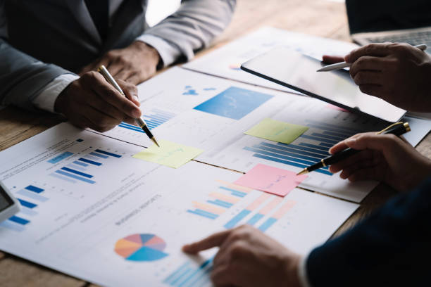istock Teamwork process, Business team using a calculator to calculate the numbers of statistic business profits growth rate on documents graph data, desk in the office. 1478943491