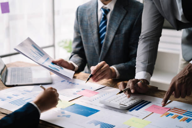 istock Business team or financial data analysts working with tablets and laptop computers and data graphs together. Plan to analyzing projects in the office. 1478943506