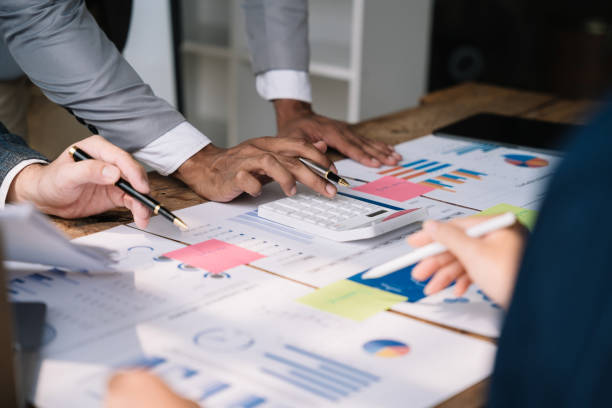 istock Business team or financial data analysts working with tablets and laptop computers and data graphs together. Plan to analyzing projects in the office. 1478943515