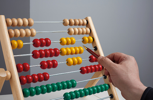 Business man calculating something with an abacus