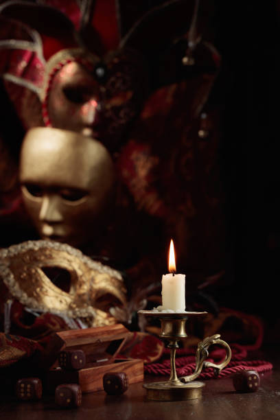 istock Burning candle, dice, and carnival masks. 1478962374