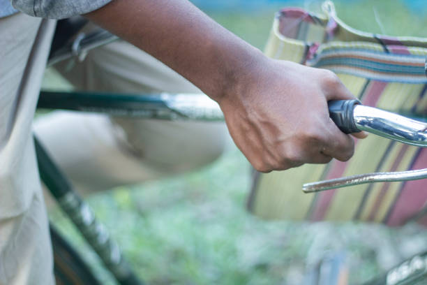 istock A black colored boy is holding a bicycle tightly with his hands 1478963787