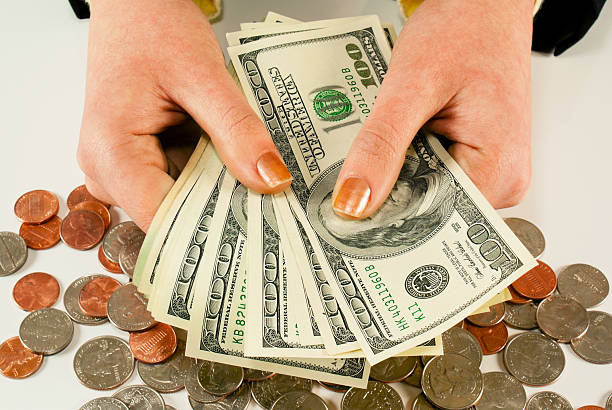 istock Female's hands with 100 US dollar bills 147896476