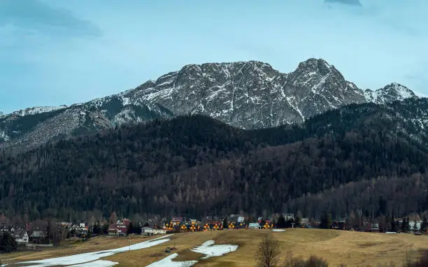 Kocielisko in the evening. Illuminated houses. View of Giewont. Western Tatras. Early spring
