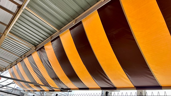 Black and yellow Awning with roof below looking