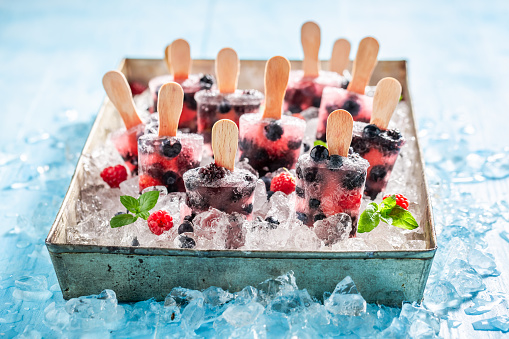 Delicious and homemade berry fruits ice cream on cold ice. Sorbets made with water and berries.