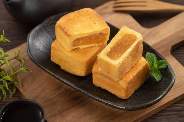 istock Delicious pineapple cake pastry in a plate on wooden table background with tea. 1478978337