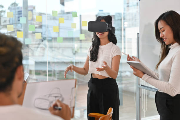 istock The development team helped design Virtual Reality Headset during meeting with their team, New innovative technology concept. 1478979202