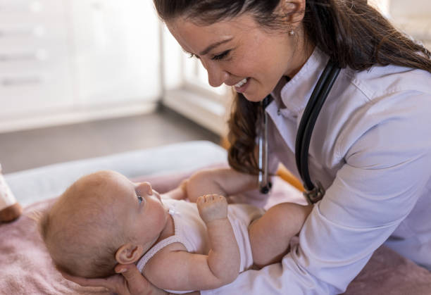 istock Young pediatrician holding little baby 1478994855