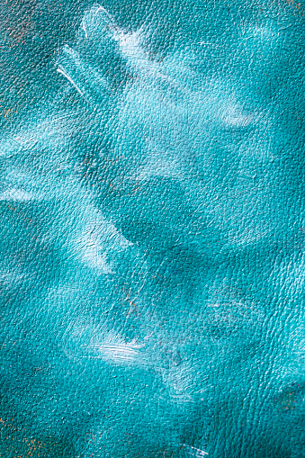 Turquoise and white oil paint brush mixed on leather texture, abstract close up wallpaper