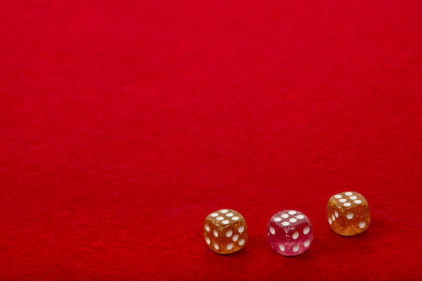 Three Dice with Value 6 on Red Velvet Playing Table - Gambling and Game Concept for Luck and Chance Games
