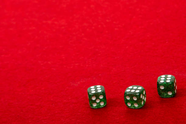 Three Dice with Value 6 on Red Velvet Playing Table - Gambling and Game Concept for Luck and Chance Games