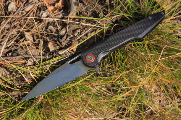 istock Folding Knife On Green Grass Closeup 1479008127