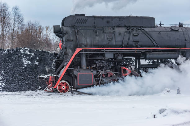istock Retro steam locomotive before coal loading at winter morning. 1479013910