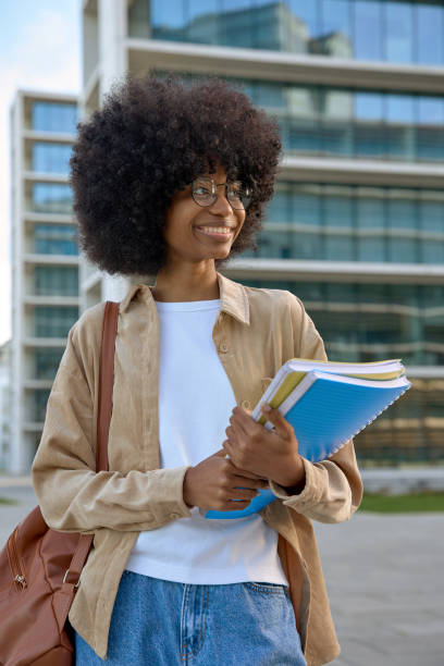istock A portrait of a smart student looking aside standing outdoors. 1479014331