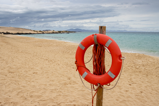 A Mariña beach, lifebuoy float, rocky coastline A Mariña , Lugo province, Galicia, Spain. Copy space available on the right.