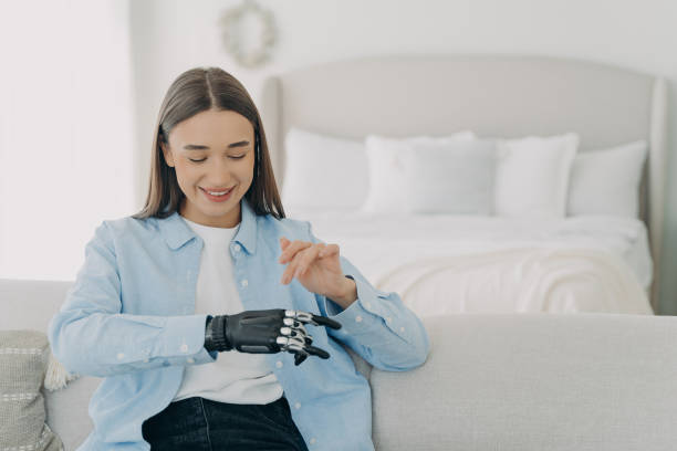 istock Happy girl is setting her electronic bionic limb. Engineering and innovation concept. 1479029696