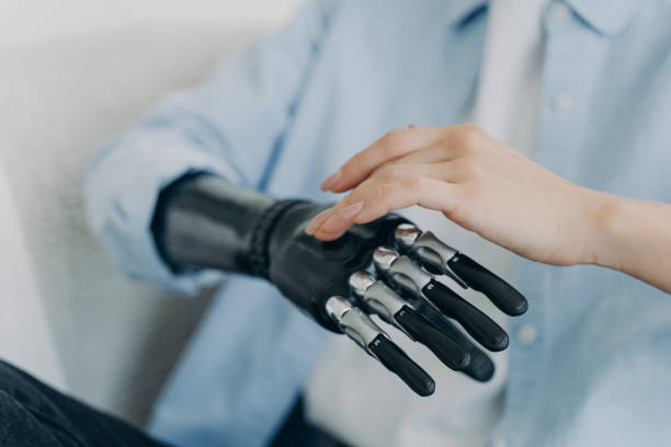 istock Hands of handicapped girl setting up her bionic arm and pressing buttons. Robotic bionic prosthesis. 1479030214