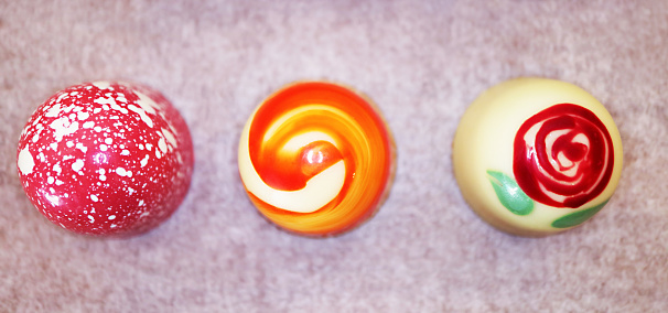 Three of Beautiful Chocolate Bonbon in Various Colors and Patterns