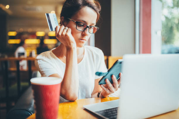 istock Woman in cafe making online payments 1479036227