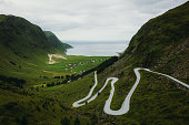 Scenic aerial view of mountain hairpin road to village by the sea in Norway