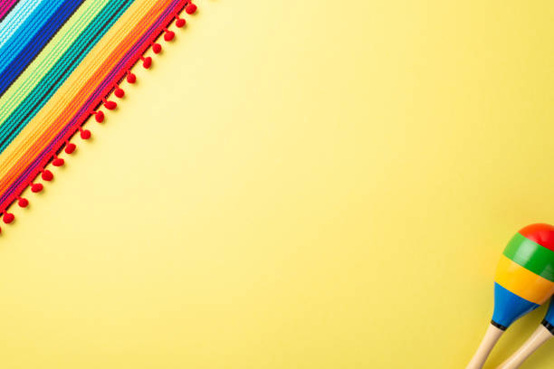 istock A top view of poncho, and maracas on light yellow background with empty space 1479042204