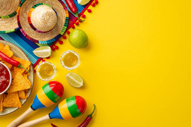istock Cinco-de-mayo celebration concept. Top view photo of nacho chips salsa sauce chilli tequila with salt lime sombrero hats colorful serape and maracas on isolated bright yellow background with copyspace 1479042550