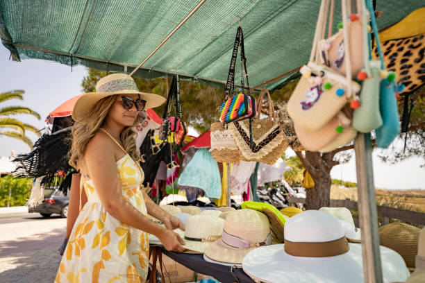istock Woman buying sun hat on the beach 1479046521