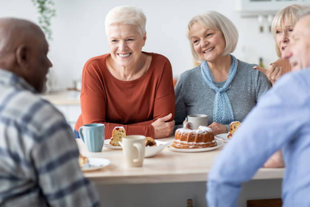 istock Happy senior friends drinking tea with cake together 1479050350