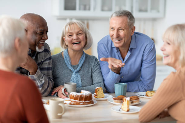 istock Multiracial group of happy senior people drinking tea with cake 1479050381