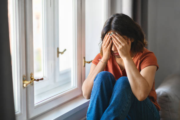istock Depression Concept. Young Arab Woman Crying While Sitting Near Window At Home 1479050688