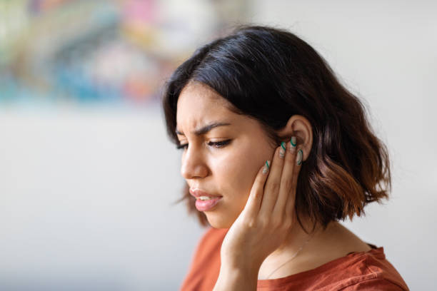 Ears Pain. Sick Young Arab Woman Suffering From Earache At Home Ears Pain. Sick Young Arab Woman Suffering From Earache At Home, Upset Middle Eastern Female Having Otitis Illness And Healthcare Problems, Millennial Lady Frowning While Rubbing Sore Auricle neuralgia stock pictures, royalty-free photos & images