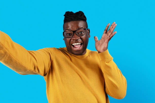 istock Cheerful Black Young Man Wearing Eyeglasses Taking Selfie Over Blue Background 1479050744