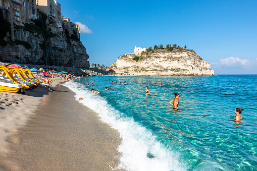 Tropea, Italy – August 18, 2020: Tropea, Italy – Aug. 2020: Vacationers swimming in the crystal clear waters of Tropea, a famous seaside resort town of Calabria region