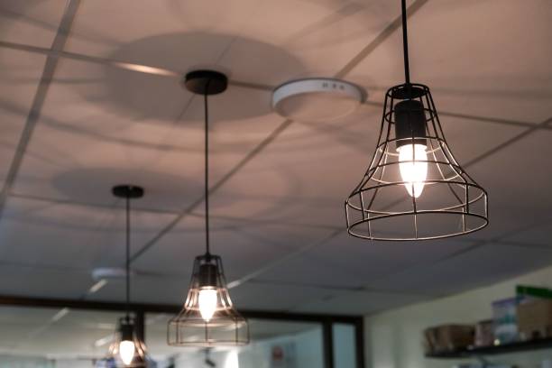 istock an industrial looking space that has multiple lamps hanging above it 1479058962