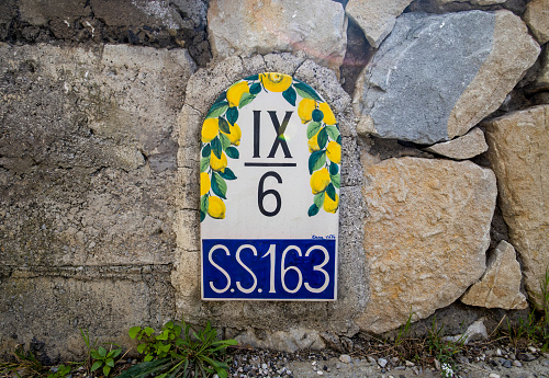 Positano, Italy - March 2023: A decorative mile marker on the road along the Amalfi Coast near Positano, Italy
