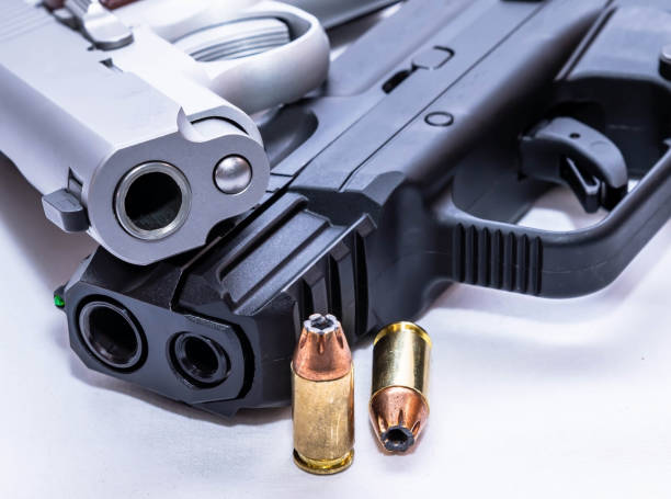 istock Two pistols along with hollow point bullets 1479067992