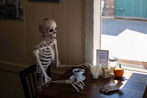 istock skeleton is drinking a coffee with a cup full of disgusting cockroaches 1479069015